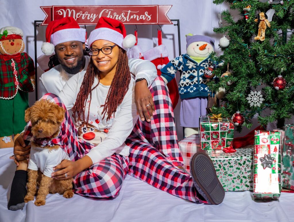 A Couple Sitting Beside the Christmas Tree