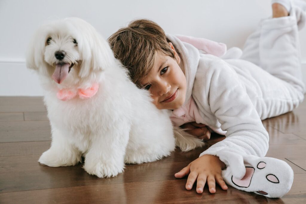 Boy Lying on the Floor Beside a Dog