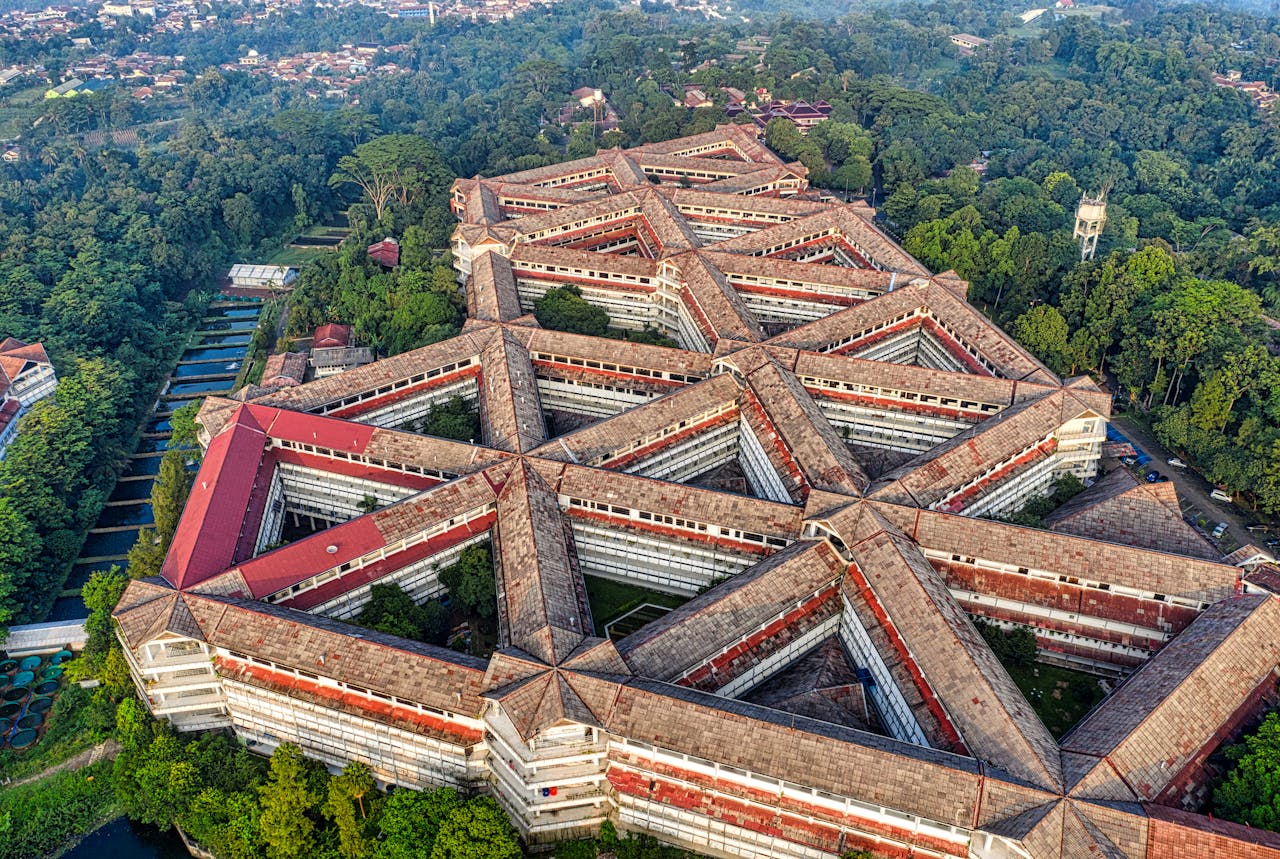 Drone shot of a distinctive geometric building in lush surroundings of Jawa Barat, Indonesia.